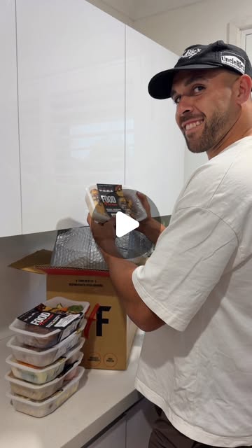 William Kennedy unpacking Food4Fitness meals