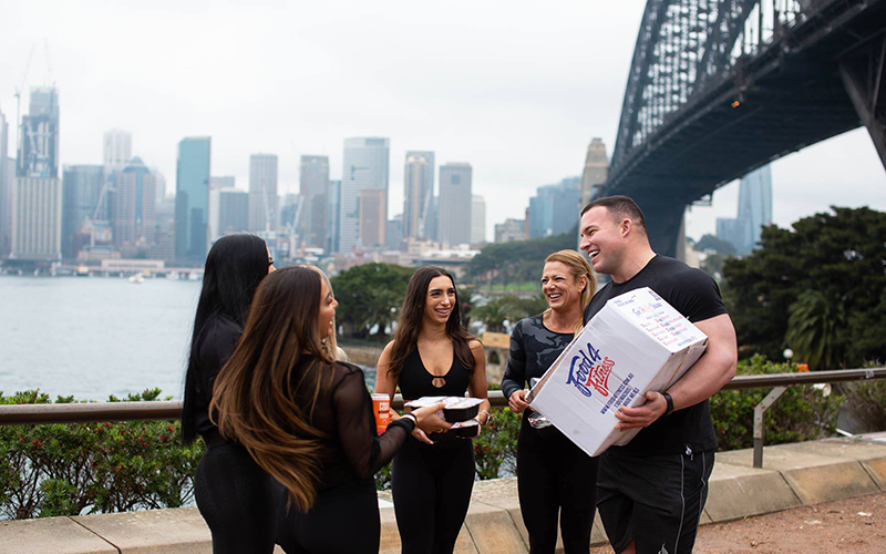 Group with Food4Fitness meals beside Sydney Harbour Bridge